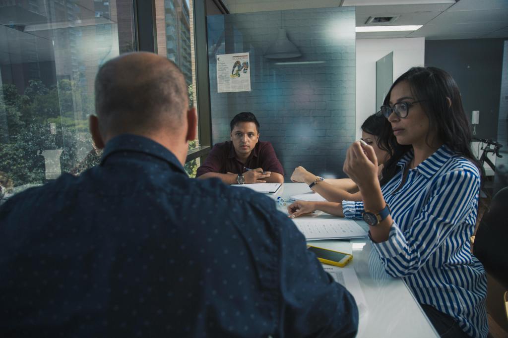 Men and women sitting around a conference table